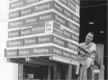 Photo of a man lifting a pallet of Heidelberg beer on a forklift.